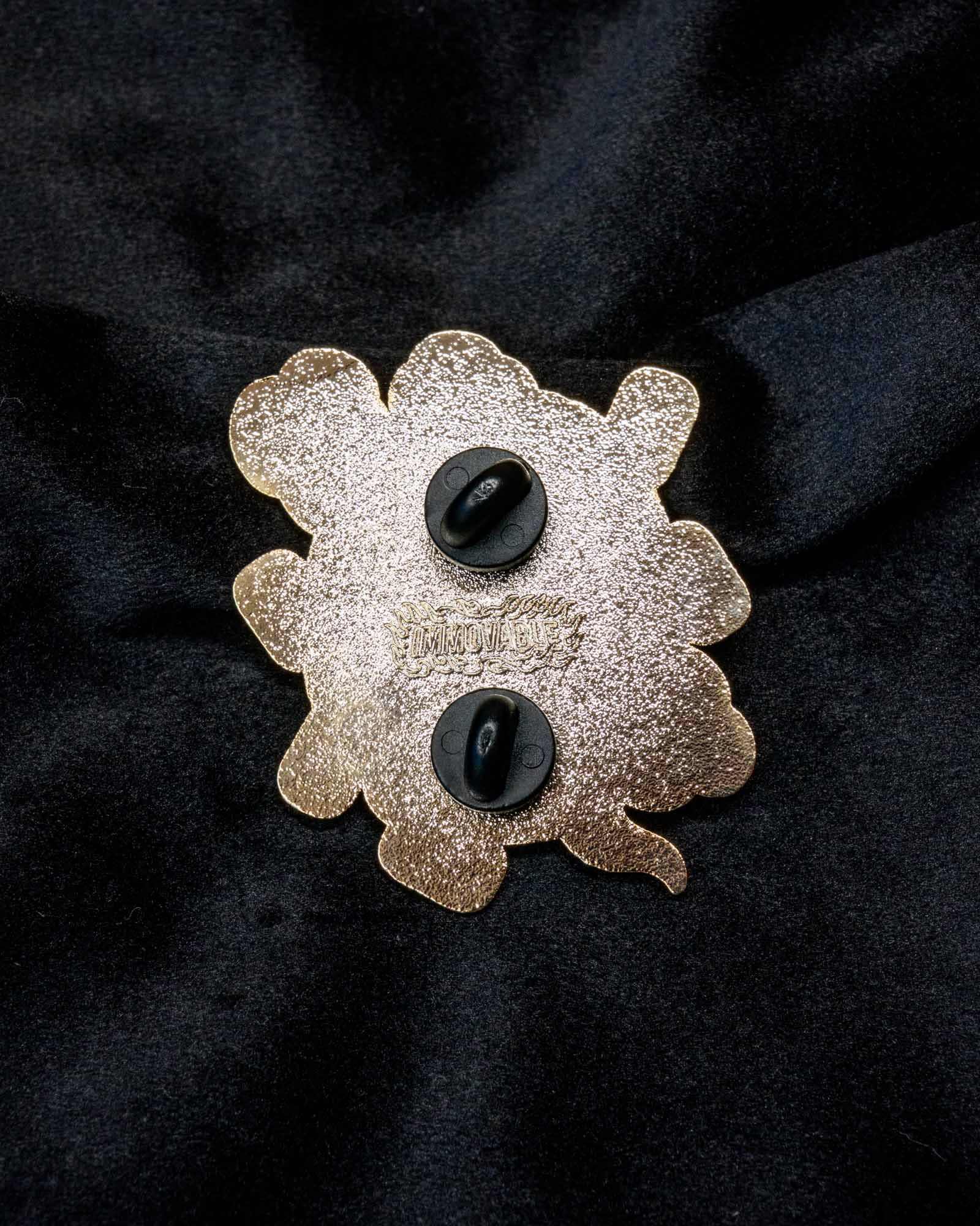 Daruma enamel pin from the Immovable collection by Geoffrey Wong, featuring a red Daruma design symbolizing perseverance, luck, and determination.