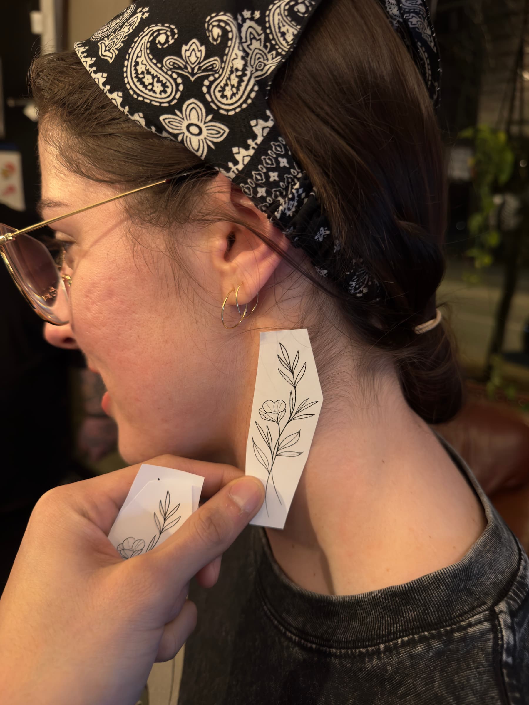 client at 46 tattoo toronto trying on tattoo sizes