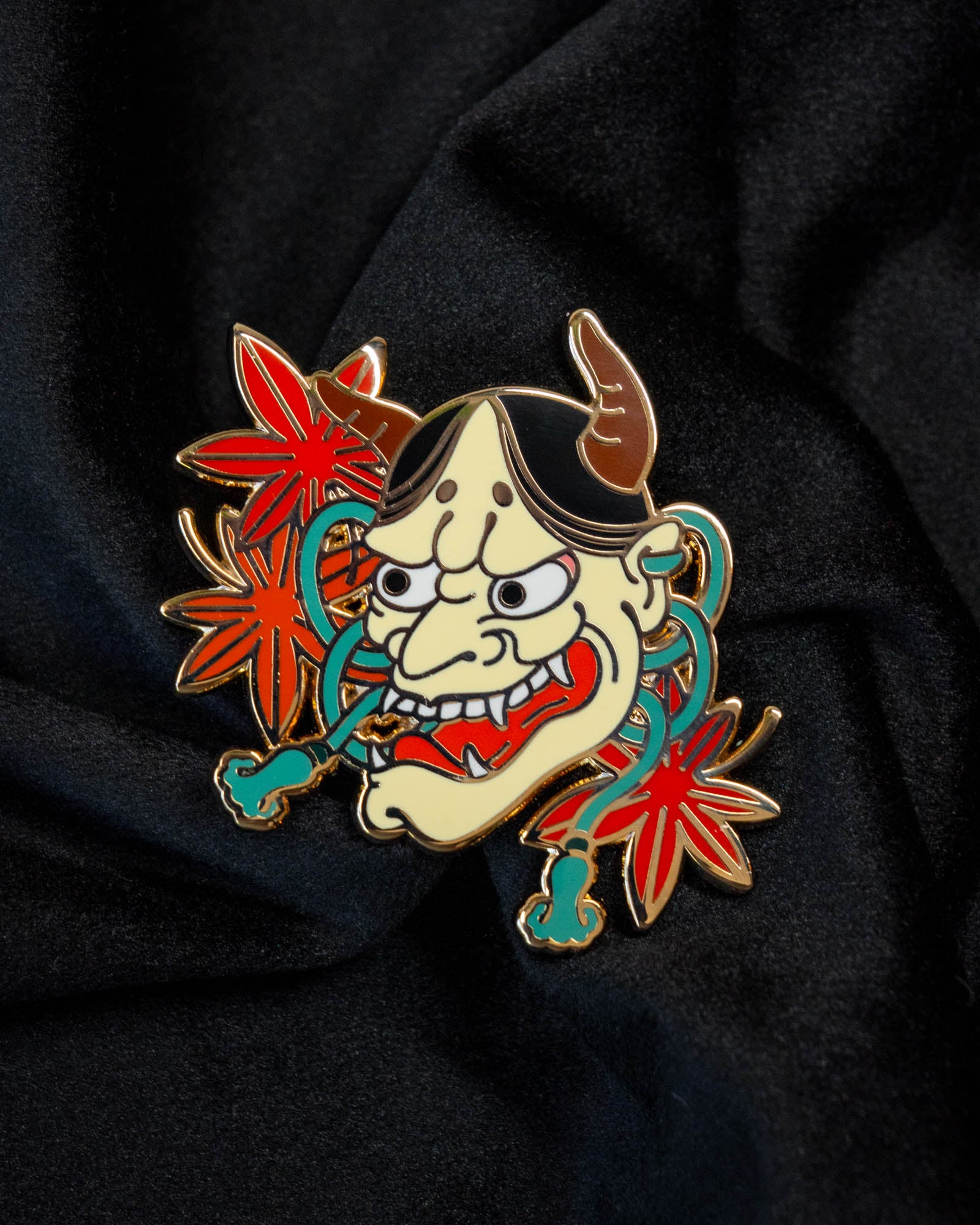Hannya Mask enamel pin from the Immovable collection by Geoffrey Wong, featuring a traditional Japanese mask design expressing the duality of rage and sorrow.