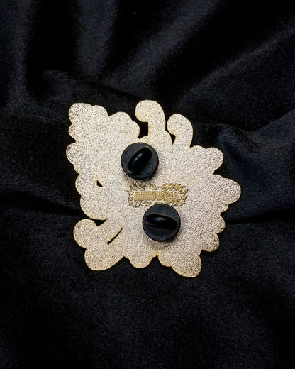 Chrysanthemum enamel pin from the Immovable collection by Geoffrey Wong, featuring a red and green Japanese tattoo-inspired floral design symbolizing renewal and longevity.