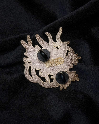 Dragon enamel pin from the Immovable collection by Geoffrey Wong, depicting a green dragon surrounded by flames symbolizing wisdom, power, and protection.