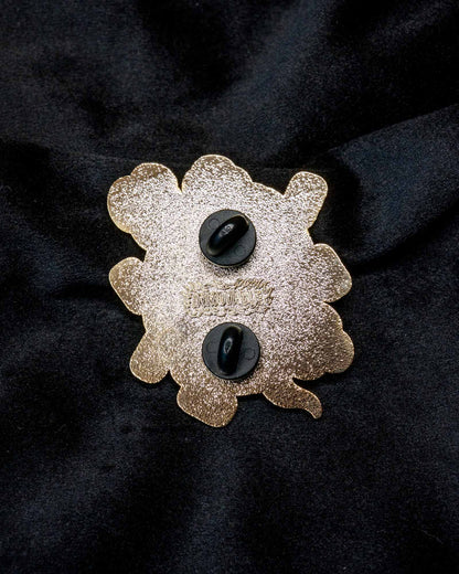 Daruma enamel pin from the Immovable collection by Geoffrey Wong, featuring a red Daruma design symbolizing perseverance, luck, and determination.