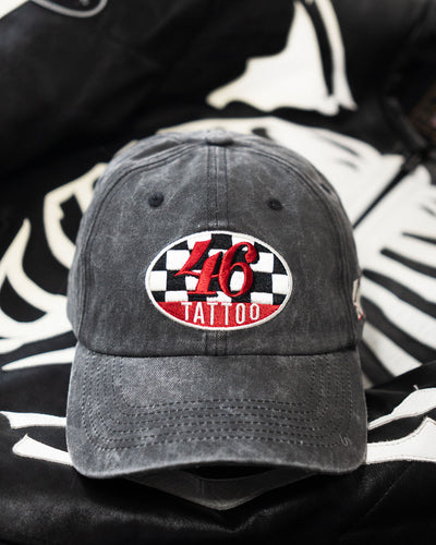 Black cap with a red and white "46 tattoo" logo on a black and white patterned background