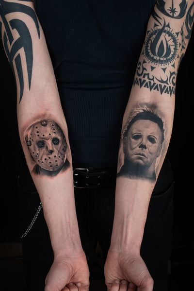 Black and grey realism couple tattoos inspired by Jason Voorhees and Michael Myers on opposite forearms
