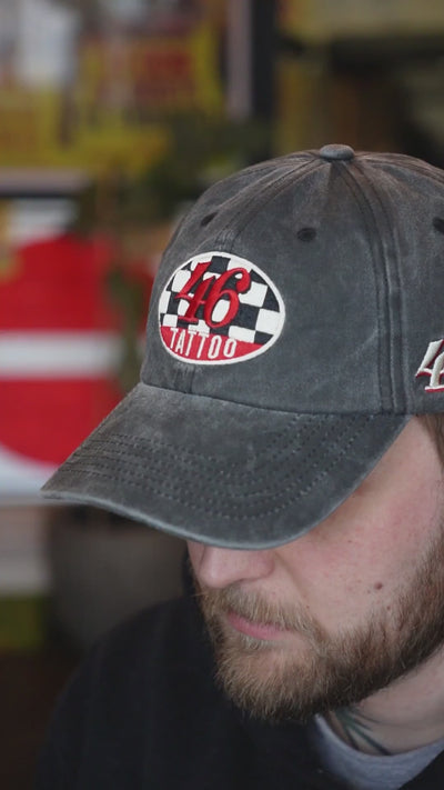 Video of a man wearing a cap with "46 tattoo" logo